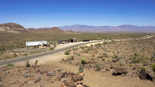 Pan right of the Black Mountains, vintage gas station and historic Route 66 near Kingman, Arizona. 4K UHD video.