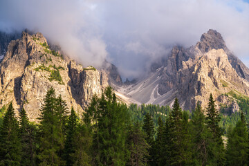 Huge mountains in  clouds. Beautiful mountain landscape. Rocky peaks of  Dolomites. The Dolomites are a favorite place for tourists and rock climbers. Italy. South Tyrol