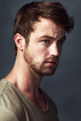 Obraz premium Man, thinking and serious in studio for reflection, contemplating future and gray background. Male person, remember and memory for perspective or insight, wondering and daydreaming of solution