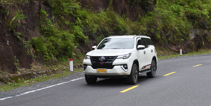 Toyota Fortuner SUV on the road in the mountains.