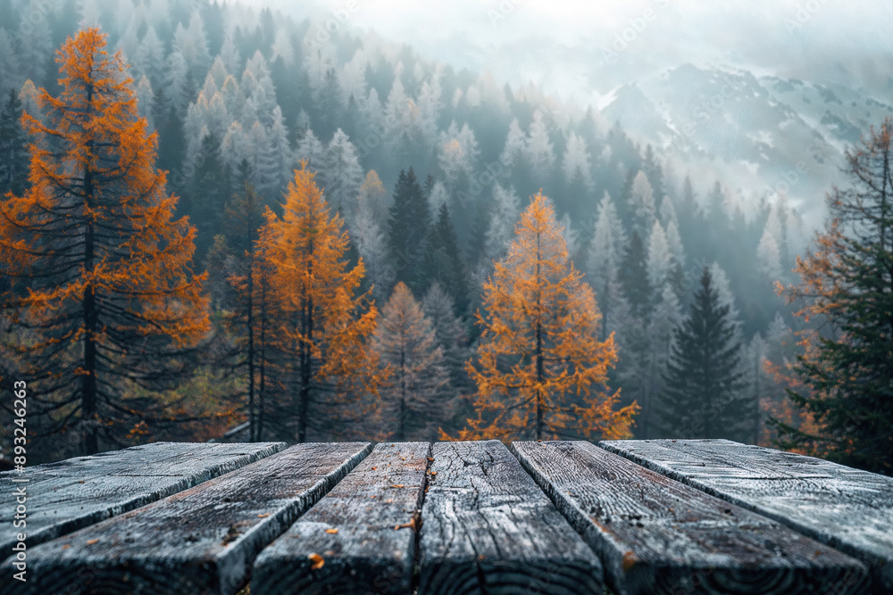 Aufkleber empty wooden table top with a breathtaking view of a misty forest with golden larch trees in autumn