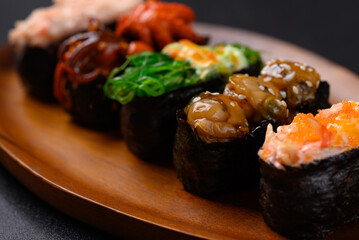 Gunkan maki sushi set on wooden plate, Japanese food