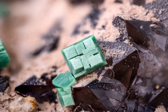 green Metatorbernite on quartz, macro photography detail texture. Specimen from Margabal Mine, Entraygues-sur-Truyère, Aveyron, Occitanie, France. close-up polished semi-precious gemstone.