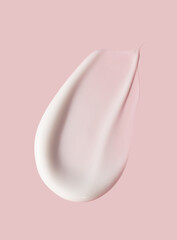 creamy smear of white cosmetic texture close up on pink background skin care concept