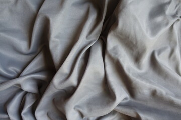 Fototapeta premium Gray simple unprinted polyamide fabric in soft folds