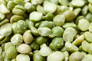 Uncooked, split, green peas background. Dry peas grains. Close-up