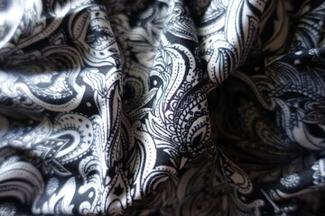 Rumpled black and white ornamental jersey fabric