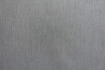 Top view of light gray polyester fabric with herringbone pattern