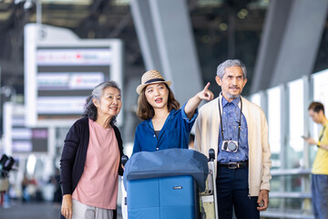 Group of Asian family tourist passenger with senior is leaving airport terminal for transportation during their vacation travel and long weekend holiday concept