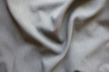 light gray polyester fabric with herringbone pattern in soft folds