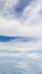 View of clouds and blue sky from an airplane window