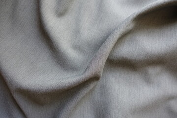 Rumpled light gray polyester fabric with herringbone pattern