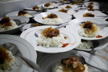 Rawon, a traditional Indonesian black beef soup. Served in a bowl with bean sprouts, chili paste, and salted egg. Ready to eat during village celebrations