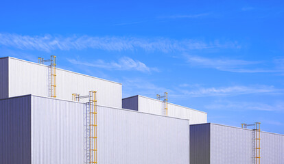 Group of industrial factory buildings with cylinder ladders on aluminium corrugated iron wall...