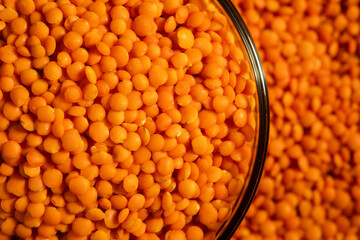 Red lentils in bowl on a lentils background