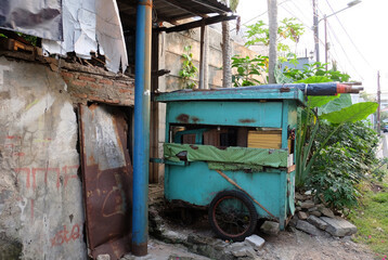 Fototapeta premium Old street vendors' carts parked at a roadside in a residential area.