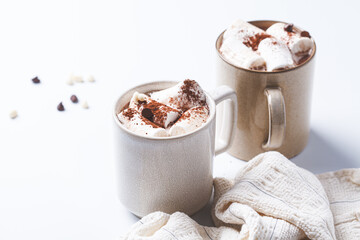 Winter hot chocolate with marshmallows in mug on white background. Christmas drink concept.