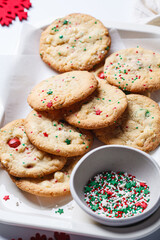 Christmas cookies with white chocolate and green-red sprinkles, white background.