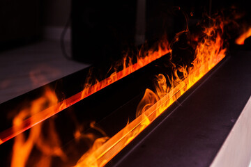 Close-Up of Electric Fireplace Flames in Modern Interior. A close-up view of realistic flames in a...