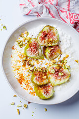 Breakfast cottage cheese with figs and maple syrup.