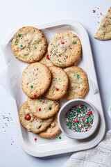 Christmas cookies with white chocolate and green-red sprinkles, white background.