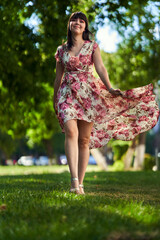 Beautiful woman in floral dress in the park