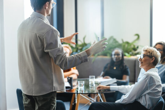 Business man giving an explanation of his goals for the company in a team meeting
