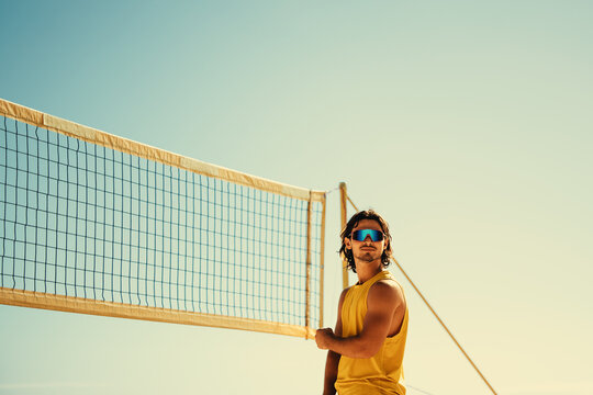 Pro volleyball player soaking up the summer sun on the beach during a championship match