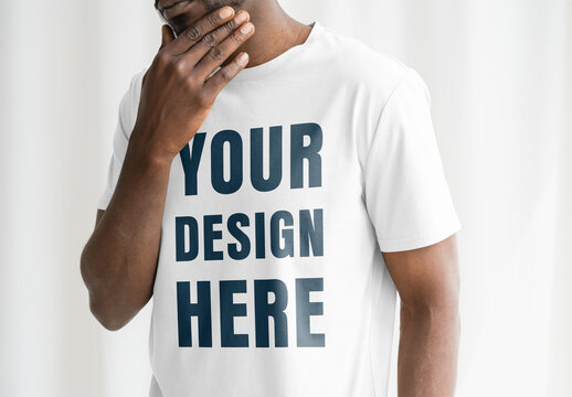 Mockup Of Man In Studio Wearing Customized T-Shirt, Touching Chin