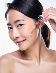 Fototapeta premium Asian Woman holding a Pipette with Skincare Serum - Applying Serum to her Face - Hyaluronic Acid, Anti Aging, Moisturiser, Repair, Hydrating, Vitamin, Ascorbic, Retinol, Exfoliant, Azelaic