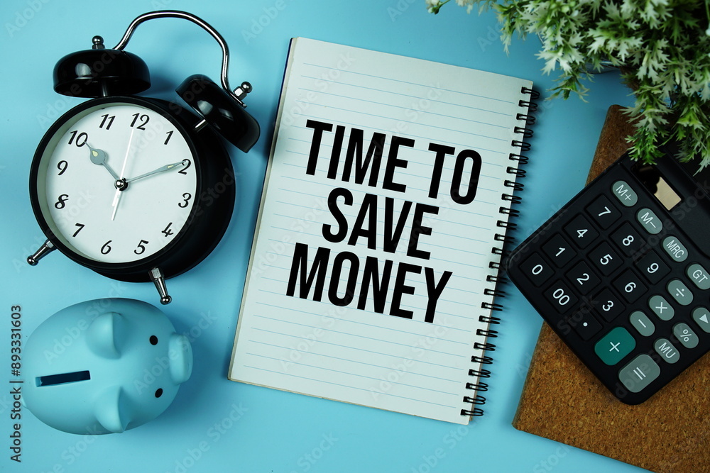 Poster time to save money text message written on note page with alarm clock, piggy bank and calculator top