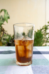 Cold Americano Coffee in a Tall Glass for Mockup use. Cold Coffee Pouring on Ice in a Cafe 