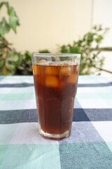 Cold Americano Coffee in a Tall Glass for Mockup use. Cold Coffee Pouring on Ice in a Cafe 