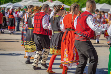 Bulgarian Folk Dancers Performing the Horo in Traditional Attire
