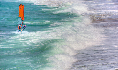 Beautiful cloudy sky with Windsurfer Surfing The Wind On Waves In Alanya