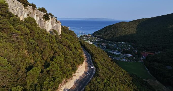 Drone following cars moving toward the Rabac resort, sunny day in Istria, Croatia