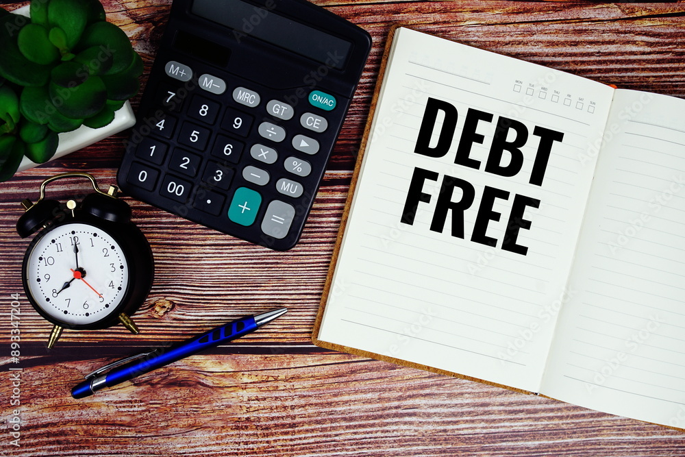 Poster debt free text written on paper torn with calculaton and alarm clock top view on wooden background