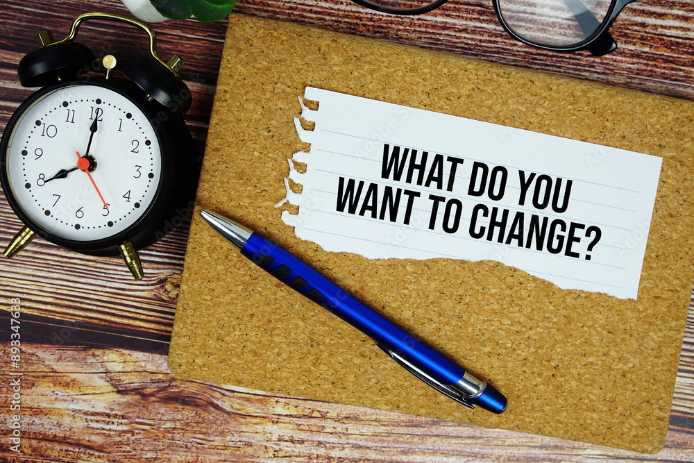 Poster what do you want to change? text written on paper torn with pen top view on wooden background
