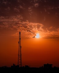 beautiful sunset with trees, clouds and tower