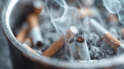 Ashtray densely filled with cigarette butts emitting smoke, symbolic of habitual smoking, addiction, and the inevitable accumulation of waste as a result.