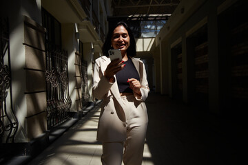 business woman in a suit works during rush hour. a young girl hurries to a meeting. young...