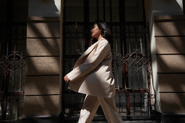 business woman in a suit works during rush hour. a young girl hurries to a meeting. young entrepreneur. freelancer. successful business