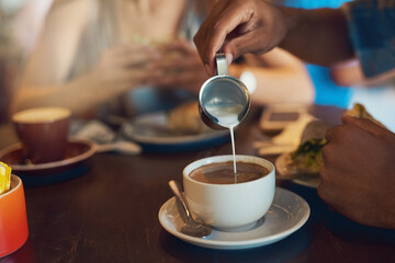 Pour, person and milk in coffee at cafe with latte art, creative and pattern process of barista for breakfast caffeine. Warm, beverage and expresso with cream for drawing design, foam and restaurant