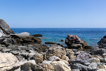 Panoramic view of a serene coastal landscape featuring calm blue waters and distant hills under a clear sky. Peaceful and tranquil scene perfect for relaxation and travel concepts.