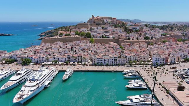 Ibiza Town, Spain: Aerial view of capital city of Ibiza island, Castle of Ibiza (Castell d'Eivissa or Almudaina) towering over Eivissa Harbour, summer day - landscape panorama of Europe from above
