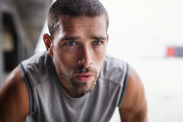 Rest, breathing and runner man with fitness break outdoor from workout, sport and training. Tired,...