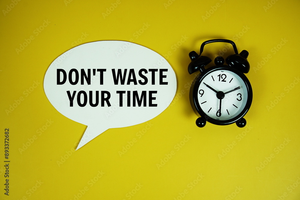Poster don't waste your time text on speech bluble with alarm clock top view on yellow background
