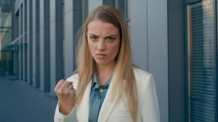 Irritated angry Caucasian woman female businesswoman entrepreneur frown looking at camera unhappy...