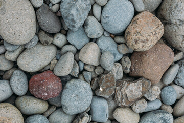 Abstract smooth round pebbles sea texture background. Stones in Faroe island