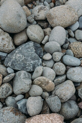 Abstract smooth round pebbles sea texture background. Stones in Faroe island